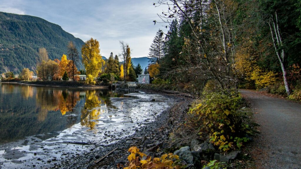 A serene lakeside scene with autumn foliage and a mountain backdrop."The Byte App's Bold Attempt to Challenge TikTok",reflecting on the app's innovative approach to social media engagement.